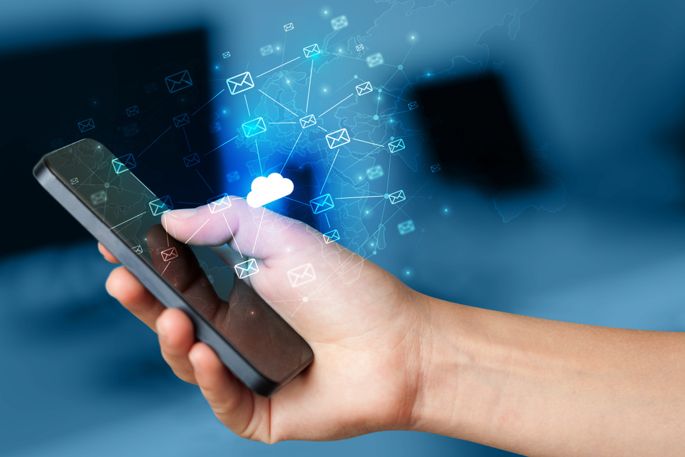 Hand using phone with cloud computing and online storage concept Hand using phone with cloud computing and online storage concept